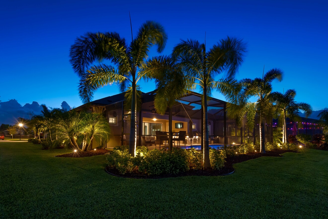 home with landscape lighting in Naples